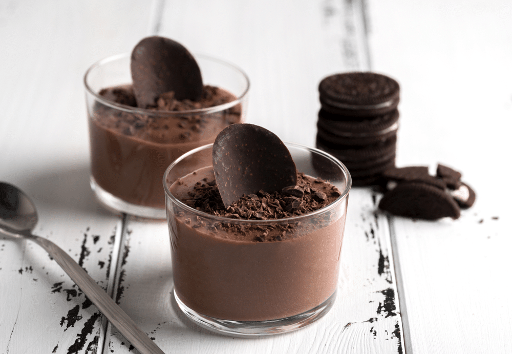 Chocolate mousse in a glasses on a white wooden background