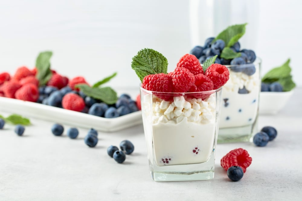 Cottage Cheese With Cream Raspberries And Blueberries Garnished With Fresh mint 