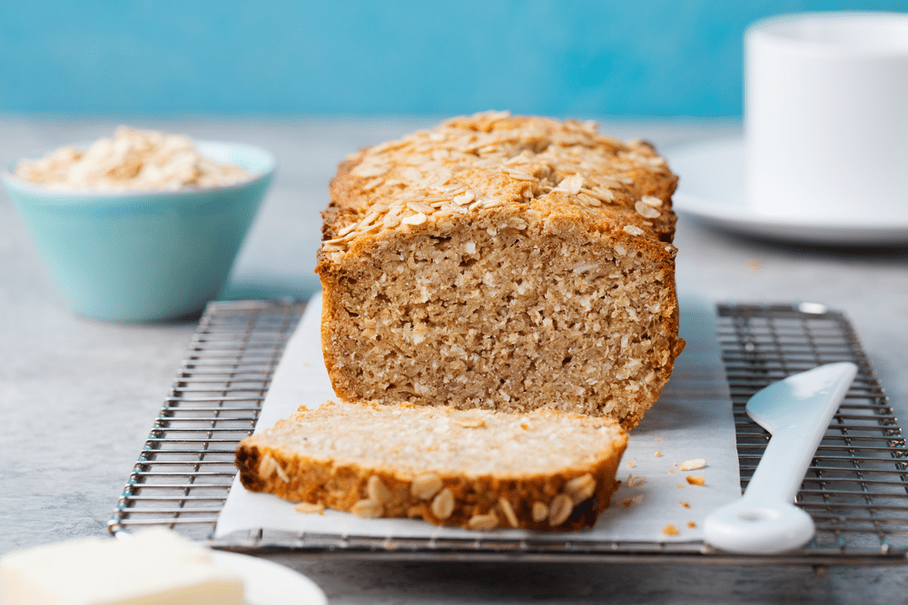 slice cut from Coconut Flour Banana Bread placed on a cooling rack