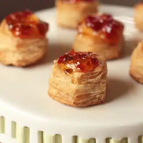 Cups of Cream Cheese Puff Pastry topped with apricot jelly