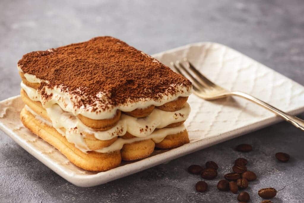 a Tiramisu in a plate along with fork