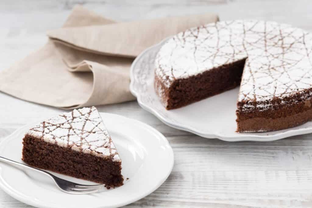 a slice of Torta Caprese along with the full Torta Caprese