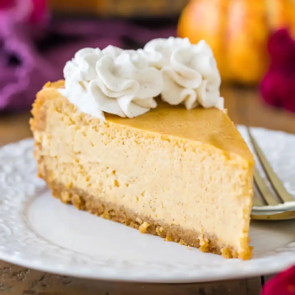 slice of pumpkin cheesecake topped with the whipped cream