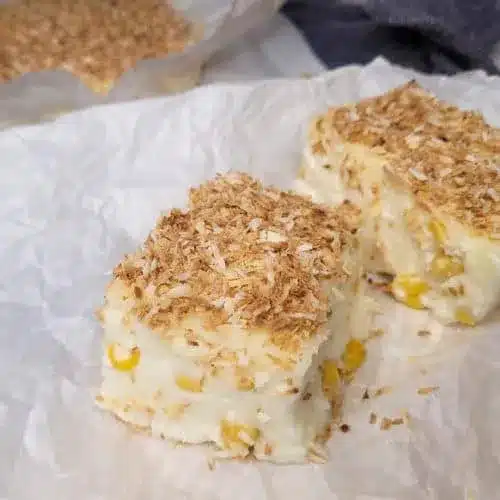 A view of a maja blanca dessert piece with almond topping