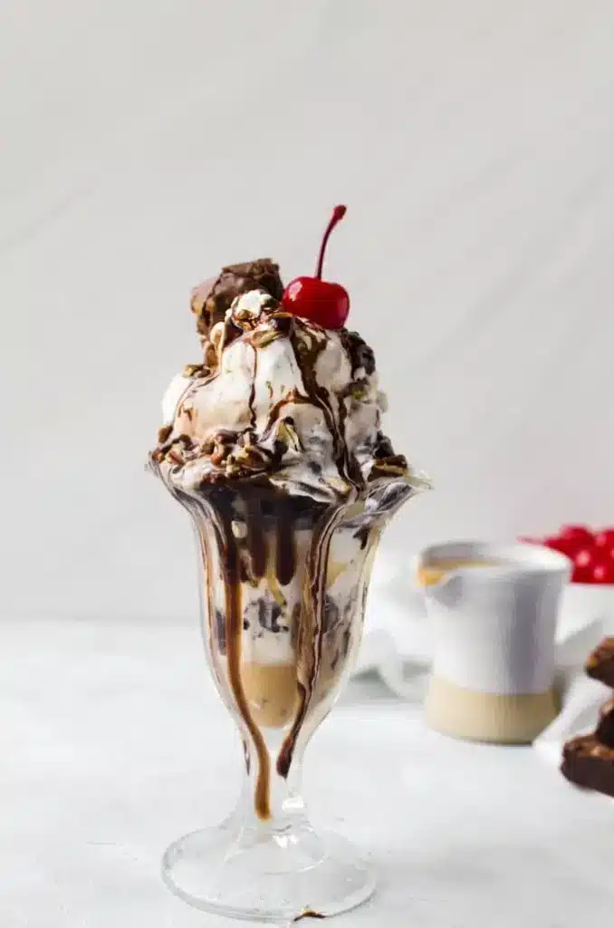 A view of a chocolate vanilla ice cream sundae with a cherry on top