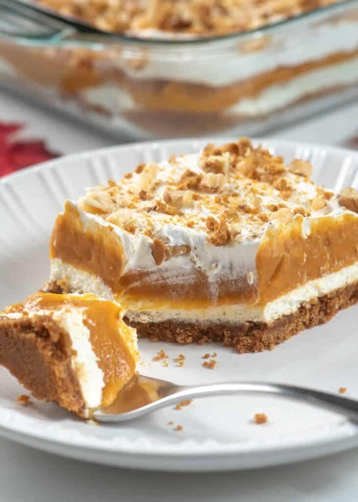 A view of a layered pumpkin dessert bite with cream