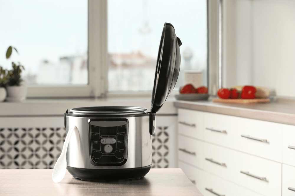 A view of an open crockpot on a kitchen table