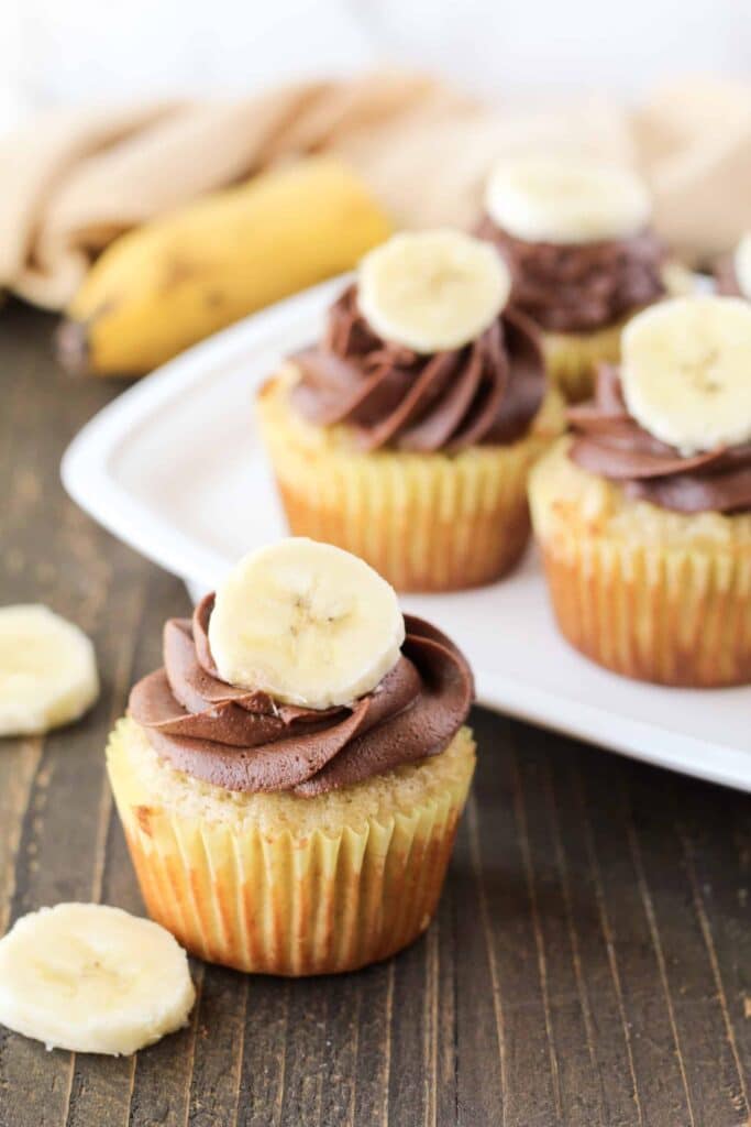 A view of chocolate banana cupcakes with banana topping on it