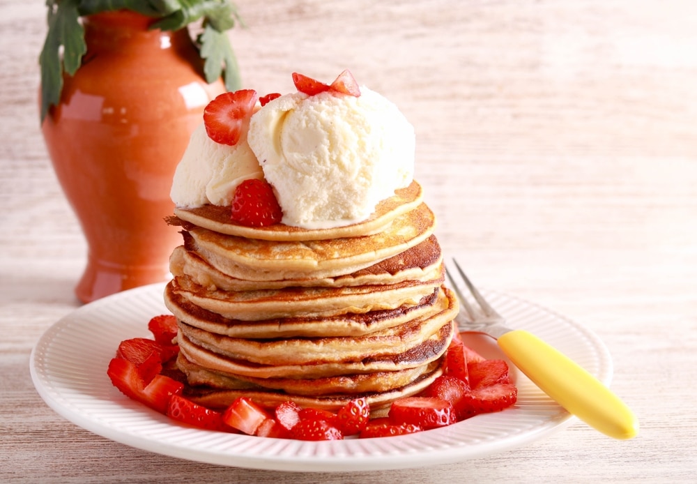 A view of pancakes with ice cream on top