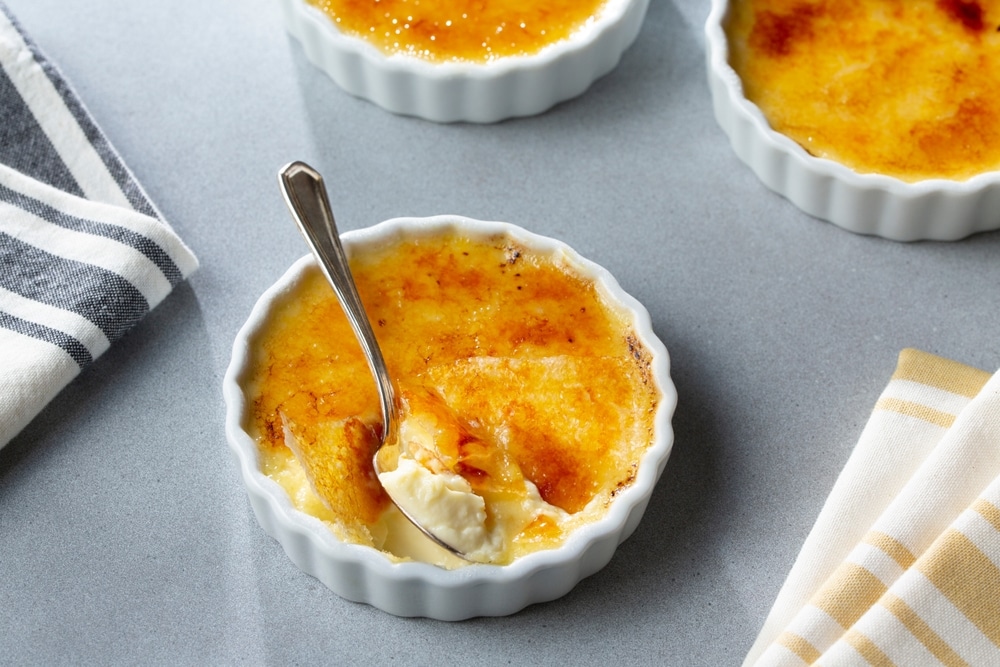 Cracked Sugar Creme Brulee Decadent Custard Dessert With Spoon 