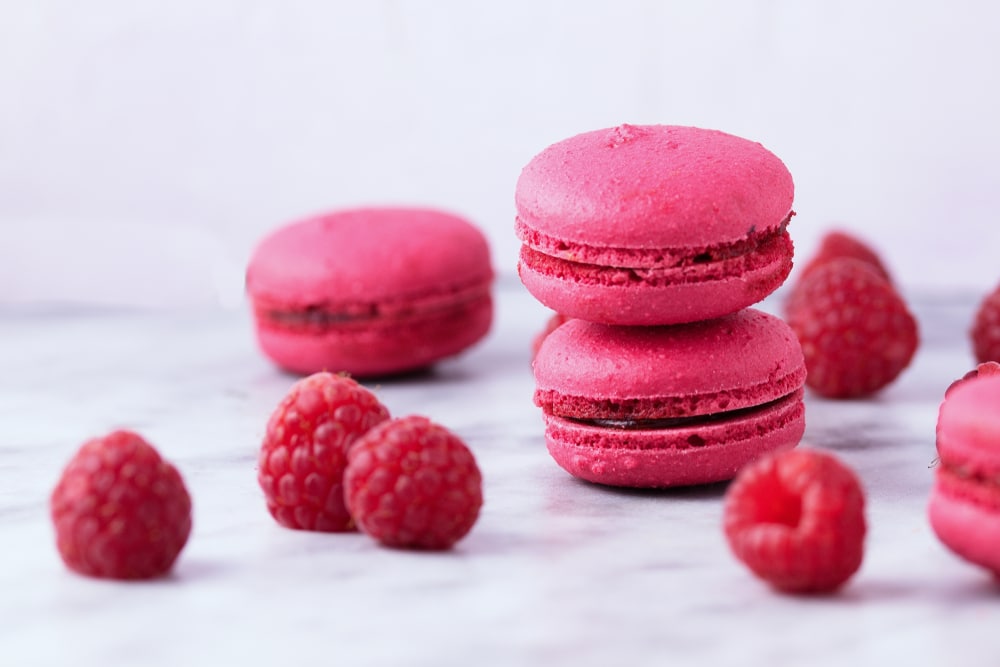 Several pieces of delicious French cookie macrons These are of raspberry flavor