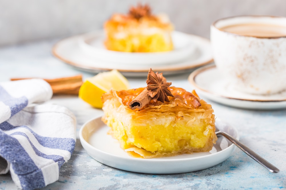 Custard Of "galaktoboureko served in plate with a cup of coffee