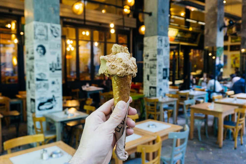 a person holding Greek Kaimaki Ice Cream In A Cone