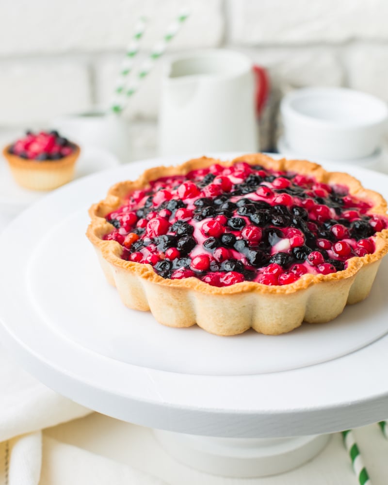 fruit tart topped with red and blue berries