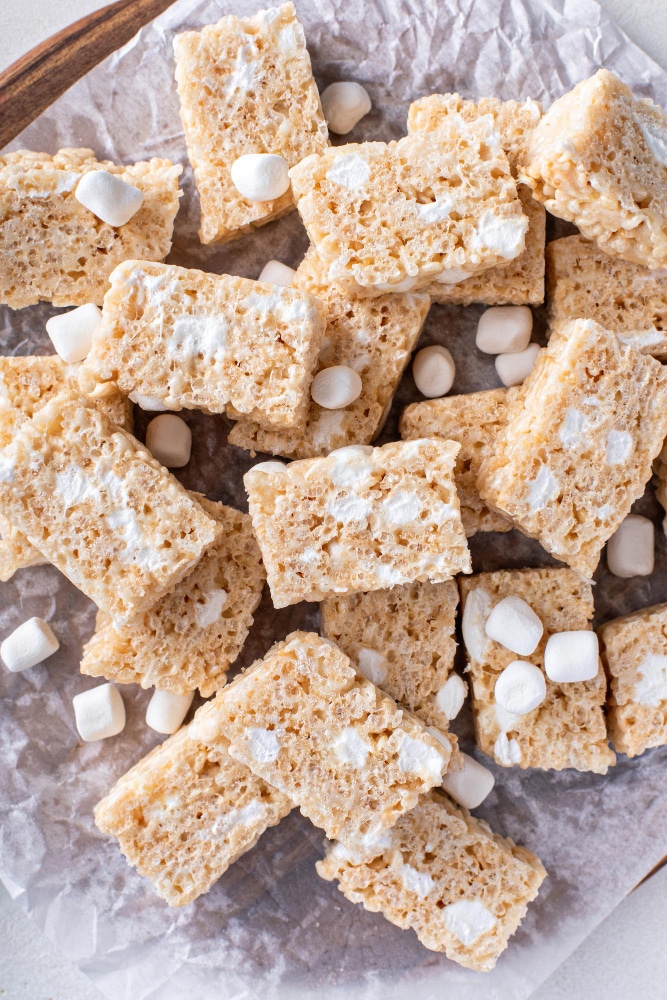 rice krispie treats cut into squares topped with marshmallows