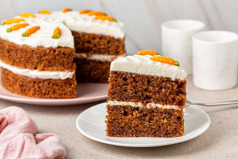 A Piece Of Homemade Carrot Cake Made With Walnuts Iced cream cheese