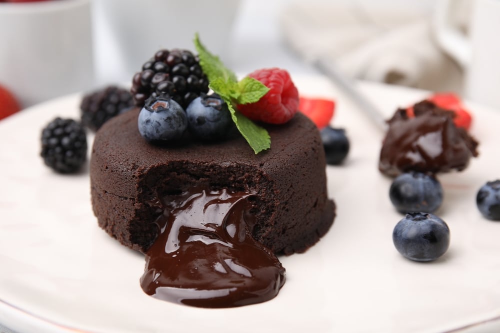 Delicious Chocolate Fondant Berries And Mint On Plate Closeup