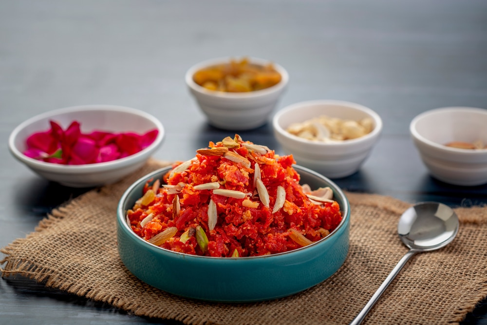 Gajar ka halwa served in a bowl garnished with cashew almond and pistachio nuts