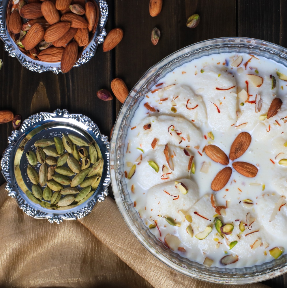 Soft Rasmalai Dipped In Sweet Milk Garnished With Almonds And