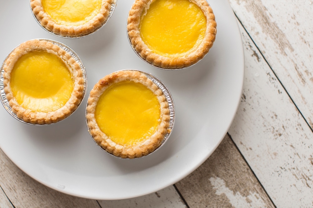 Top View Of Egg Tarts On A Wood Background