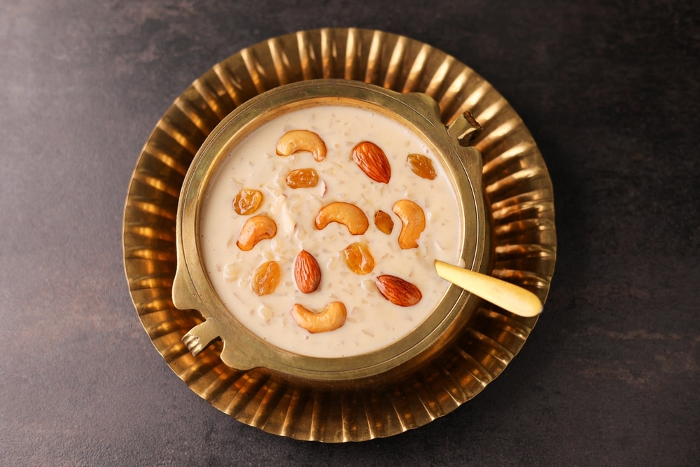 Rice Kheer served in a copper bowl with a spoon