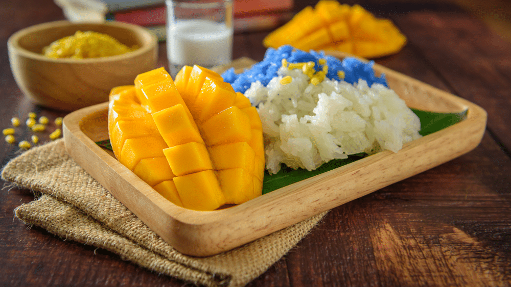 Mango sticky rice mix with coconut milk with wooden tray Thai dessert