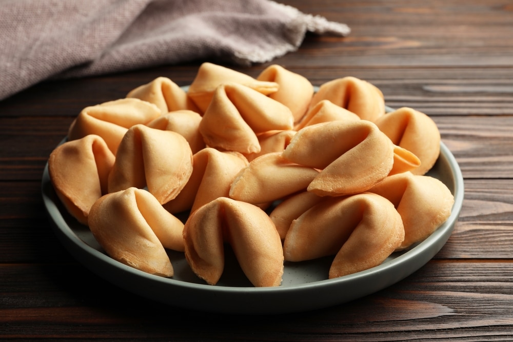 Tasty Fortune Cookies With Predictions In Plate On Wooden Table