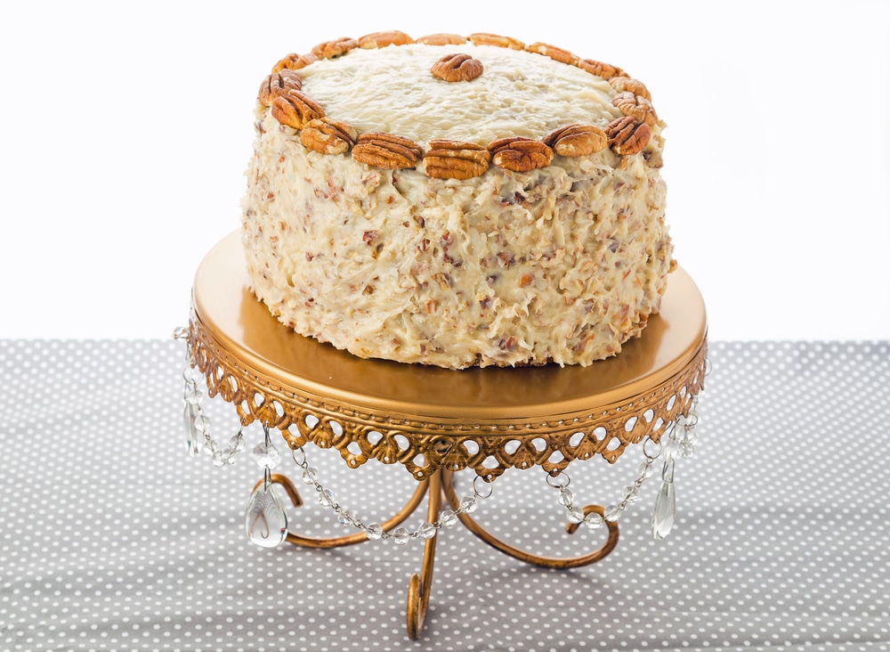 Beautiful layer Italian Cream Cake On Elegant Gold Cake Stand