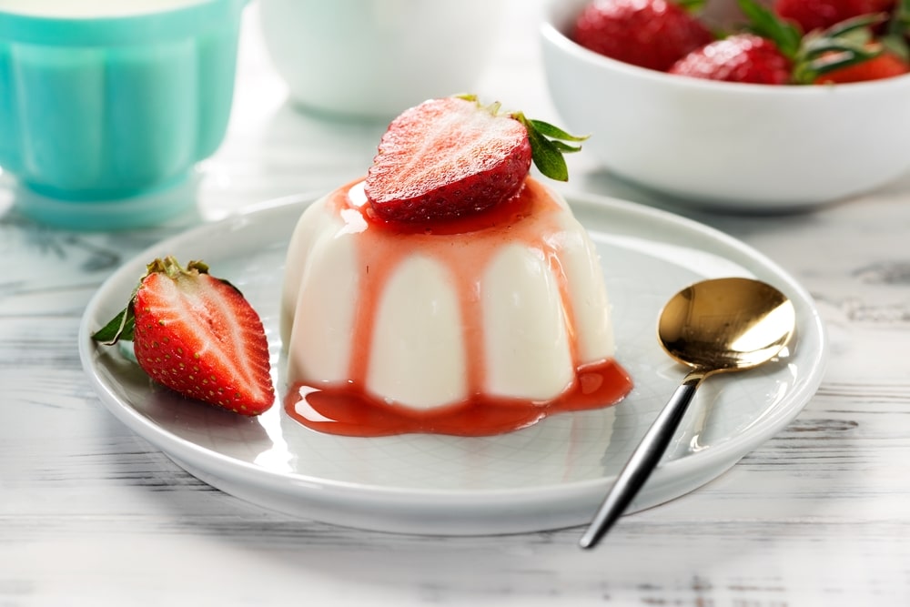 Panna Cotta Dessert With Fresh Strawberries And Berry Sauce