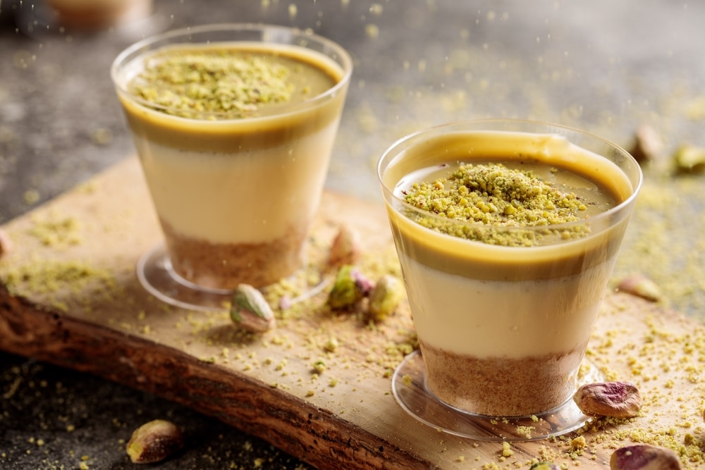 Pistachio Cheesecake Served In Cup Isolated On Wooden Board Top