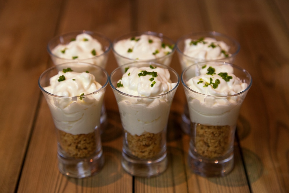 Six Mini Key Lime Pie Desserts In Small Glasses With