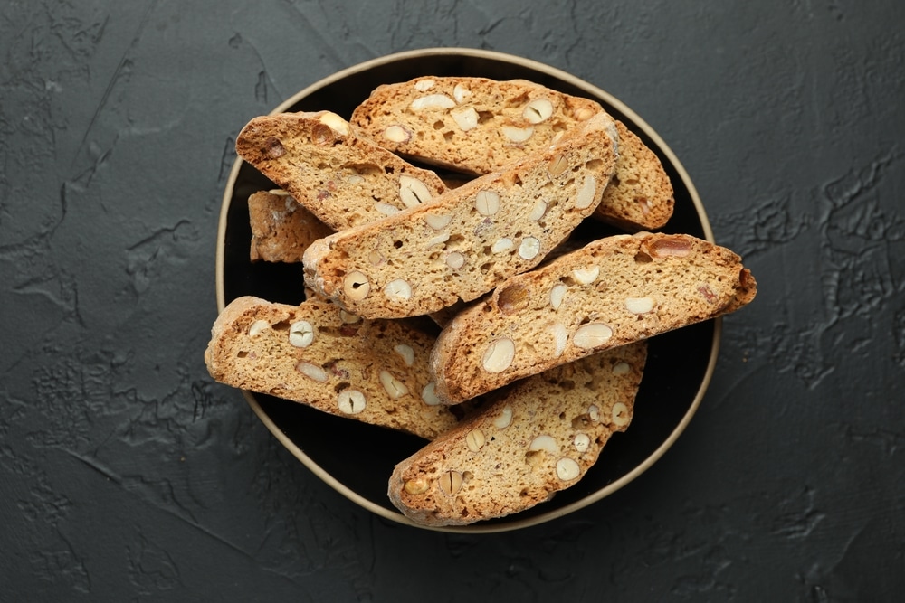 Traditional Italian Almond Biscuits (cantucci) In Bowl On Black Table