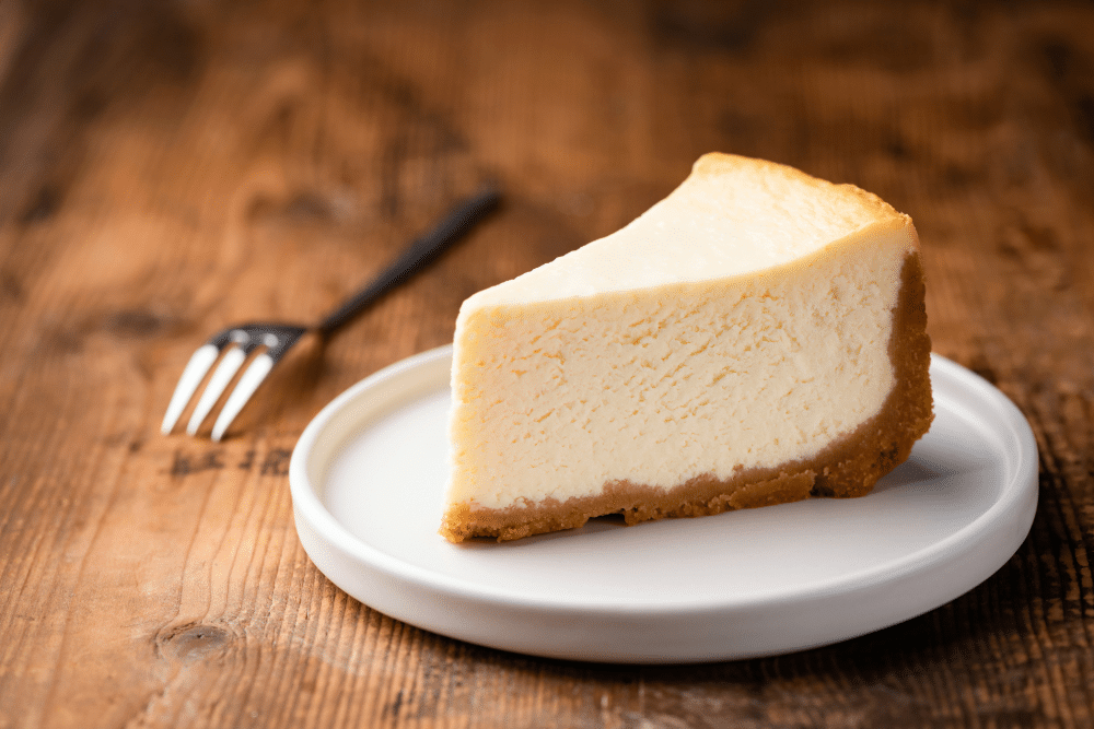 a slice of Tarta de Queso in a white plate